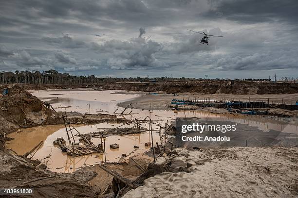 Hundreds of police officers attend an operation in illegal gold mining area of La Pampa, in Madre de Dios, southern Peruvian jungle on July 13, 2015....