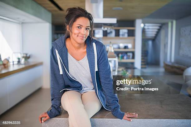 woman sitting in kitchen - hood clothing stock pictures, royalty-free photos & images