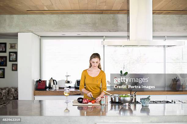 woman chopping vegetables in kitchen - kitchen bench top stock pictures, royalty-free photos & images