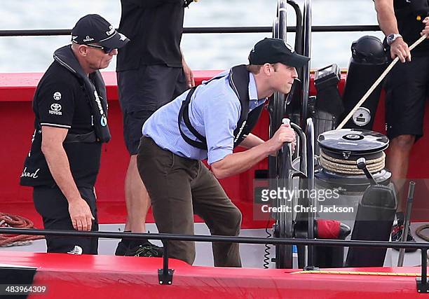 Prince William, Duke of Cambridge helms an America's Cup yacht as he races Catherine, Duchess of Cambridge in Auckland Harbour on April 11, 2014 in...