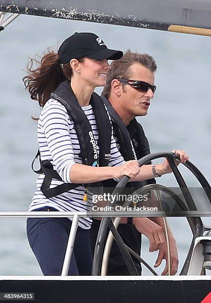 Catherine, Duchess of Cambridge helms an America's Cup yacht as she races Prince William, Duke of Cambridge in Auckland Harbour on April 11, 2014 in...