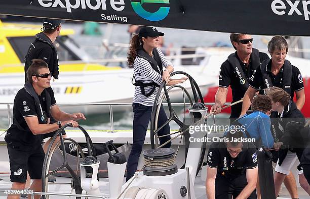 Catherine, Duchess of Cambridge helms an America's Cup yacht as she races Prince William, Duke of Cambridge in Auckland Harbour on April 11, 2014 in...