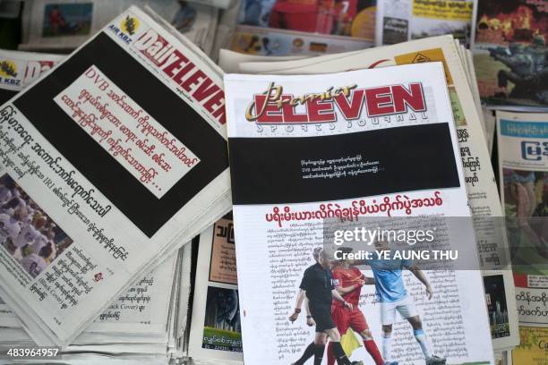 Newspapers with a black front page are displayed at a stall in Yangon on April 11 after Zaw Pe, a journalist for the Democratic Voice of Burma news...