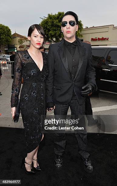 Lindsay Usich and musician Marilyn Manson attend the premiere of Warner Bros. Pictures and Alcon Entertainment's "Transcendence" at Regency Village...
