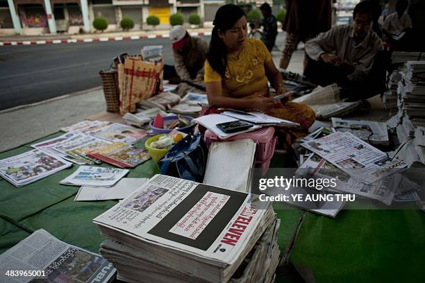 Newspapers with a black front page are displayed at a stall in Yangon on April 11 after Zaw Pe, a journalist for the Democratic Voice of Burma news...