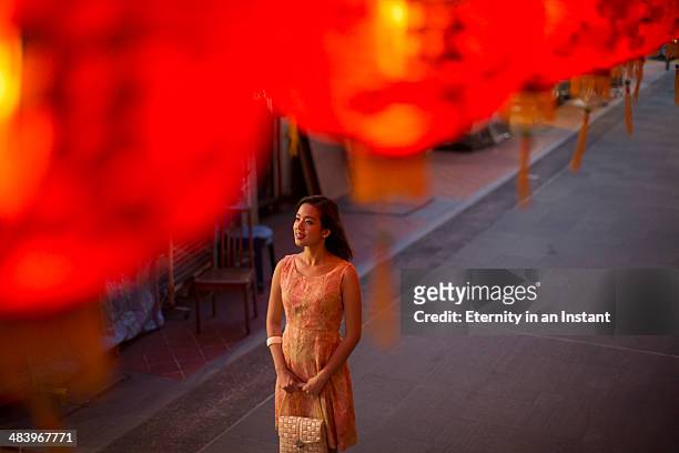 young woman looking at red lanterns at night. - chinese lantern night stock pictures, royalty-free photos & images