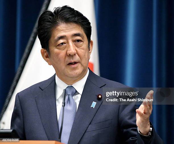 Prime Minister Shinzo Abe discusses his statement marking the 70th anniversary of the end of World War II at a press conference at his official...