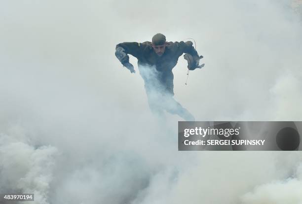 Recruit of the far-right volunteer battalion Azov takes part in a competition in Kiev on August 14, 2015 prior to leaving to the battle region in...