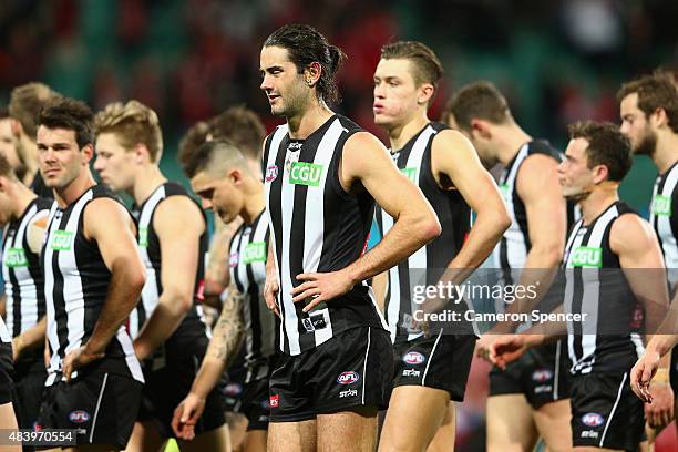 Brodie Grundy of the Magpies and team mates look dejected after losing the round 20 AFL match between the Sydney Swans and the Collingwood Magpies at...