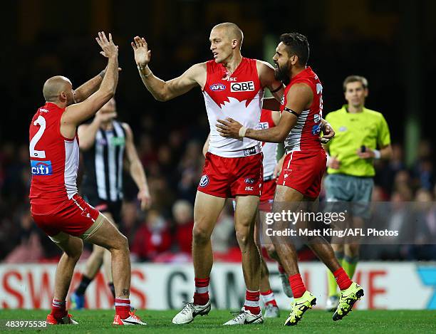 Sam Reid of the Swans celebrates with team mates after kicking a goal during the round 20 AFL match between the Sydney Swans and the Collingwood...