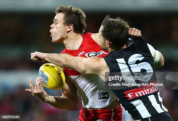 Mike Pyke of the Swans is challenged by Nathan Brown of the Magpies during the round 20 AFL match between the Sydney Swans and the Collingwood...