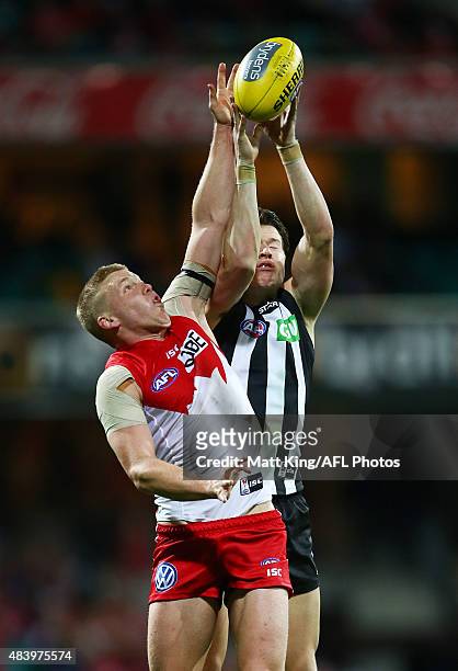 Daniel Hannebery of the Swans competes for the ball against Tom Langdon of the Magpies during the round 20 AFL match between the Sydney Swans and the...