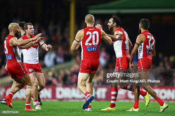 Adam Goodes of the Swans celebrates with team mates after kicking a goal during the round 20 AFL match between the Sydney Swans and the Collingwood...