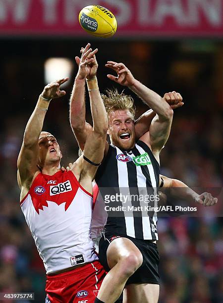 Jonathon Marsh of the Magpies is challenged by Sam Reid of the Swans during the round 20 AFL match between the Sydney Swans and the Collingwood...