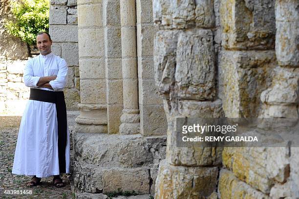 Father Guillaume Soury-Lavergne poses on August 12, 2015 outside the Benedictine abbey of Marcilhac-sur-Cele, in the Lot gorges, southern France....