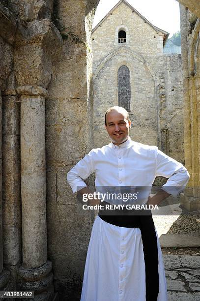 Father Guillaume Soury-Lavergne poses on August 12, 2015 outside the Benedictine abbey of Marcilhac-sur-Cele, in the Lot gorges, southern France....