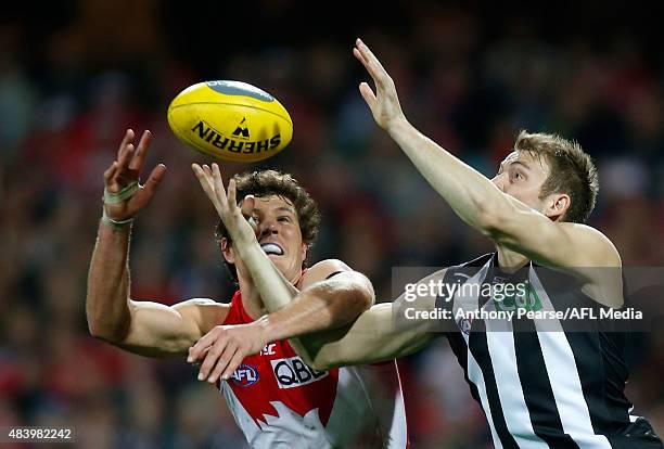 Kurt Tippett of the Swans and Ben Reid of the Magpies compete during the round 20 AFL match between the Sydney Swans and the Collingwood Magpies at...