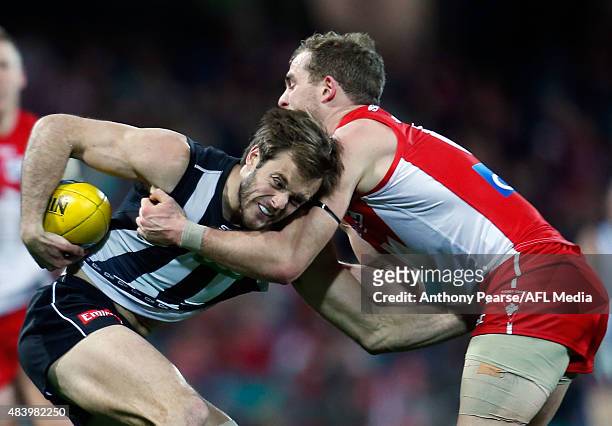 Alan Toovey of the Magpies and Tom Mitchell of the Swans compete during the round 20 AFL match between the Sydney Swans and the Collingwood Magpies...