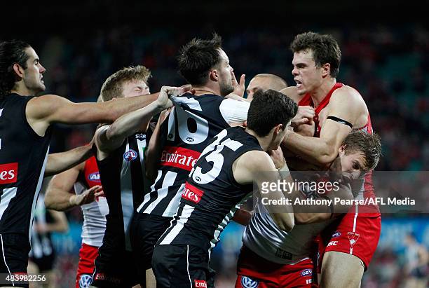 Jack Crisp and Nathan Brown of the Magpies scuffle with Kieren Jack and Mike Pyke of the Swansduring the round 20 AFL match between the Sydney Swans...