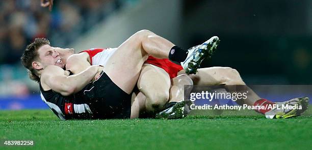 Taylor Adams of the Magpies tackles Luke Parker of the Swans during the round 20 AFL match between the Sydney Swans and the Collingwood Magpies at...
