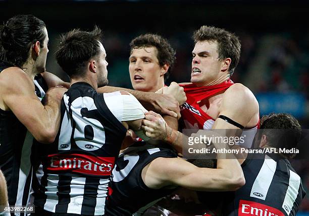 Jack Crisp and Nathan Brown of the Magpies scuffle with Kurt Tippett and Mike Pyke of the Swans during the round 20 AFL match between the Sydney...