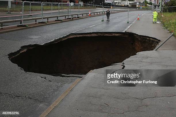 Sink hole appears on Mancunian Way in Manchester after heavy rain on August 14, 2015 in Manchester, England. Heavy rain and flood warnings have been...
