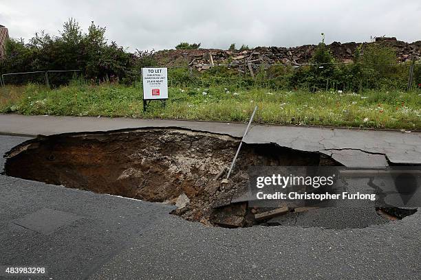 Sink hole appears on Mancunian Way in Manchester after heavy rain on August 14, 2015 in Manchester, England. Heavy rain and flood warnings have been...