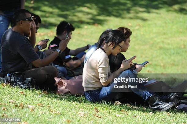 Members of the Malaysian media wait outside Dumas House which contains the Joint Agency Coordination Centre in the search for missing Malaysia...