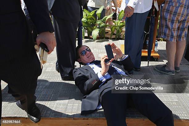 Member of the Cuban delegation lays on his back in an attempt to get a photograph the American flag as it flys over the newly reopened U.S. Embassy...