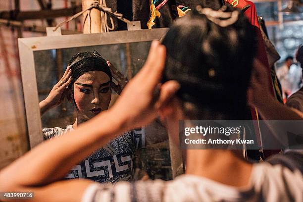 Performers prepare backstage at a Chinese opera during the month of Hungry Ghost Festival on August 14, 2015 in Hong Kong. The Hungry Ghost Festival...