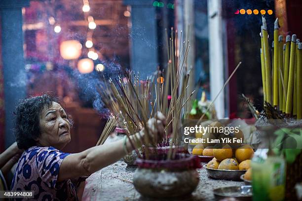 Worshipper makes offerings at a park during the month of the Hungry Ghost Festival on August 14, 2015 in Hong Kong. The Hungry Ghost Festival was...