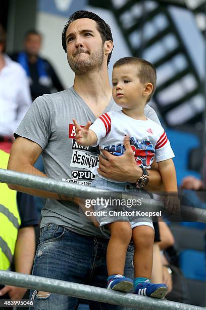Srdjan Lakic of Paderborn and his son stand on the tribune prior to the 2. Bundesliga match between SC Paderborn and SV Sandhausen at Benteler Arena...