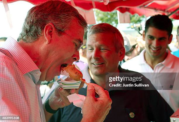Republican presidential hopeful and former Florida Gov. Jeb Bush eats a deep fried Snickers bar during the Iowa State Fair on August 14, 2015 in Des...