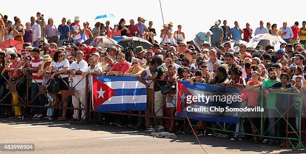Hundreds of Cubans and visitors from other countries gather along El Malecon seafront avenue outside the newly reopened U.S. Embassy to observe the...