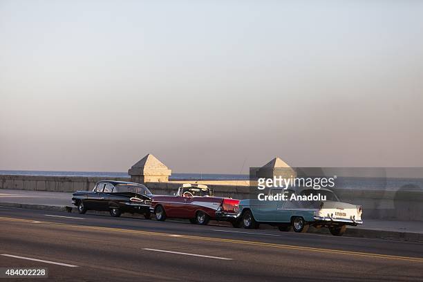 Classic American cars are parked along the road behind the American Embassy to serve as a back ground for the television cameras during the opening...