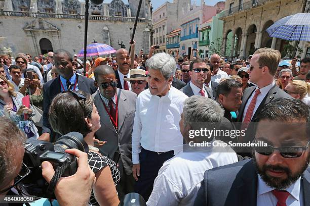 Secretary of State John Kerry is surrounded by a wall of Cuban and American security agents as he walks through San Francisco Plaza August 14, 2015...