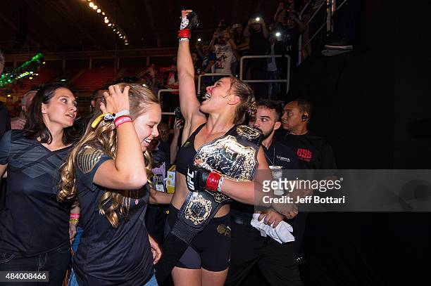 Women's bantamweight champion Ronda Rousey celebrates with her family and fans backstage after defeating Bethe Correira of Brazil by KO during the...