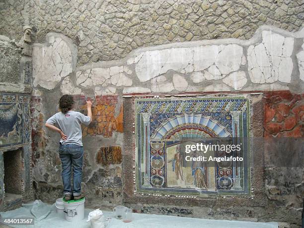 archaeologist restoring mosaic of ercolano, naples. - pompeii mosaic stock pictures, royalty-free photos & images