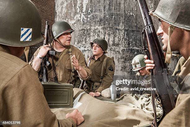 wwii sergeant explains plan to infantry squad - future soldier stock pictures, royalty-free photos & images