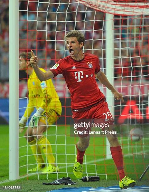 Thomas Mueller of FC Bayern Muenchen celebrates scoring his team's third goal during the Bundesliga match between FC Bayern Muenchen and Hamburger SV...