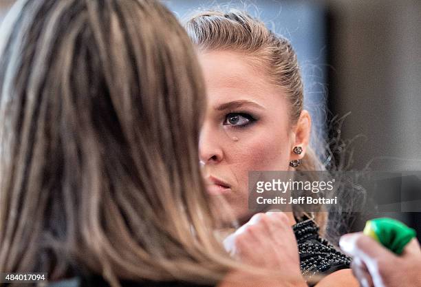Women's bantamweight champion Ronda Rousey faces off with opponent Bethe Correira of Brazil for the media during the UFC 190 Ultimate Media Day at...