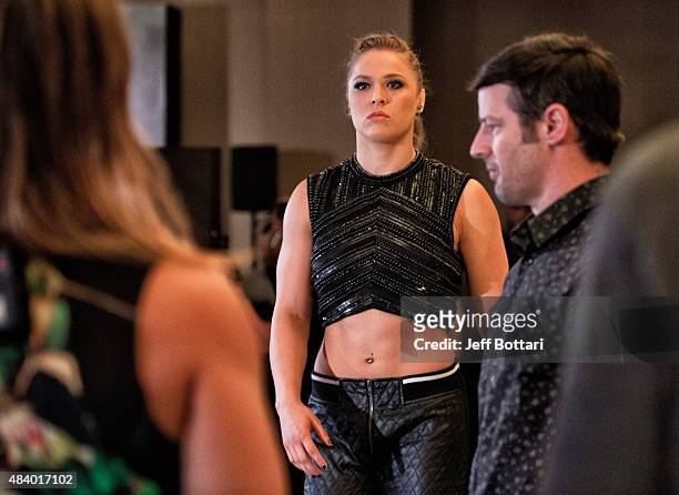 Women's bantamweight champion Ronda Rousey prepares to face off with opponent Bethe Correira of Brazil for the media during the UFC 190 Ultimate...