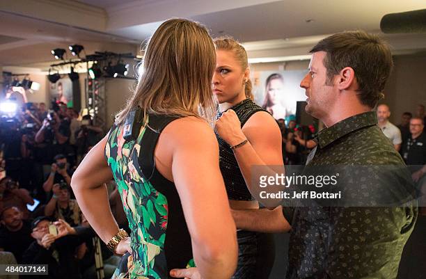 Women's bantamweight champion Ronda Rousey faces off with opponent Bethe Correira of Brazil for the media during the UFC 190 Ultimate Media Day at...