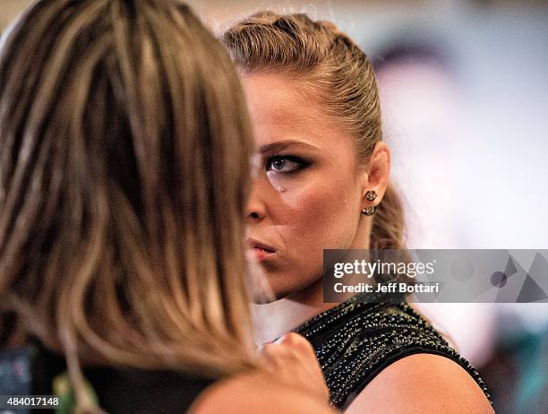 Women's bantamweight champion Ronda Rousey faces off with opponent Bethe Correira of Brazil for the media during the UFC 190 Ultimate Media Day at...