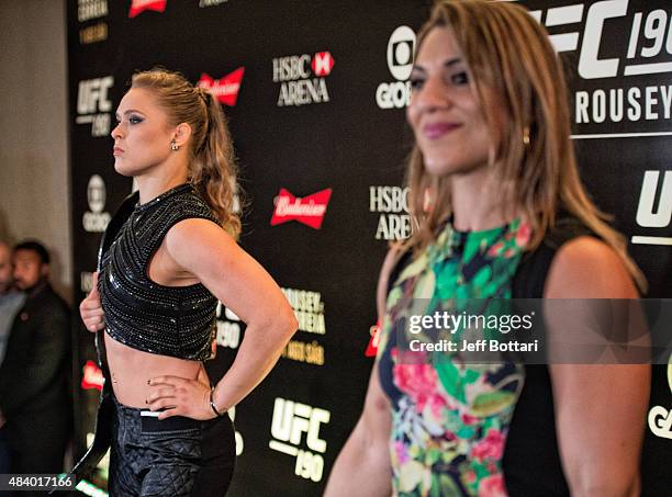 Women's bantamweight champion Ronda Rousey and challenger Bethe Correira of Brazil poses for the media during the UFC 190 Ultimate Media Day at the...