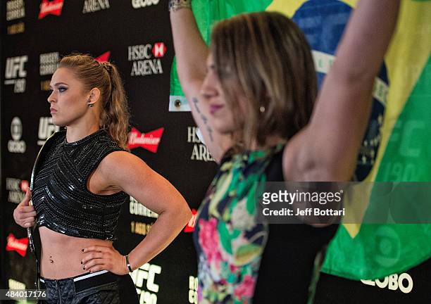 Women's bantamweight champion Ronda Rousey and challenger Bethe Correira of Brazil poses for the media during the UFC 190 Ultimate Media Day at the...