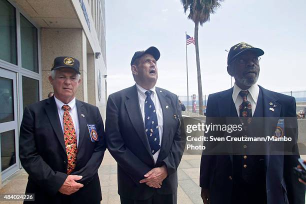 Marine Corps veterans Larry Morris, James Tracy and Francis Mike East, who took down the U.S. Flag in 1961, pose for a photo after the flag-raising...