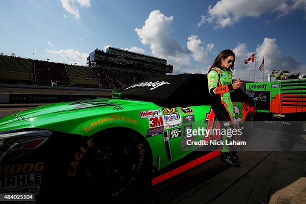 Danica Patrick, driver of the GoDaddy Chevrolet, stands on the grid during qualifying for the NASCAR Sprint Cup Series Pure Michigan 400 at Michigan...