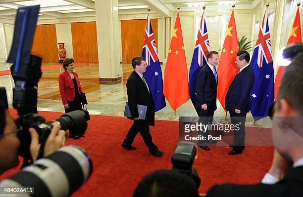 Chinese President Xi Jinping greets Australian Prime Minister Tony Abbott before a meeting at the Great Hall of the People on April 11, 2014 in...