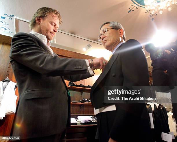 Nobel Prize in Chemistry laureate Eiichi Negishi arranges the tailcoat ahead of the Nobel Prize Award Ceremony on December 7, 2010 in Stockholm,...